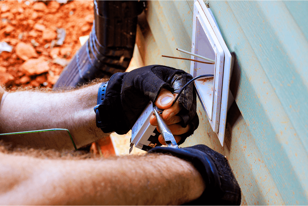 Licensed electrician installing a GFCI outlet for outdoor safety in Texas Hill Country