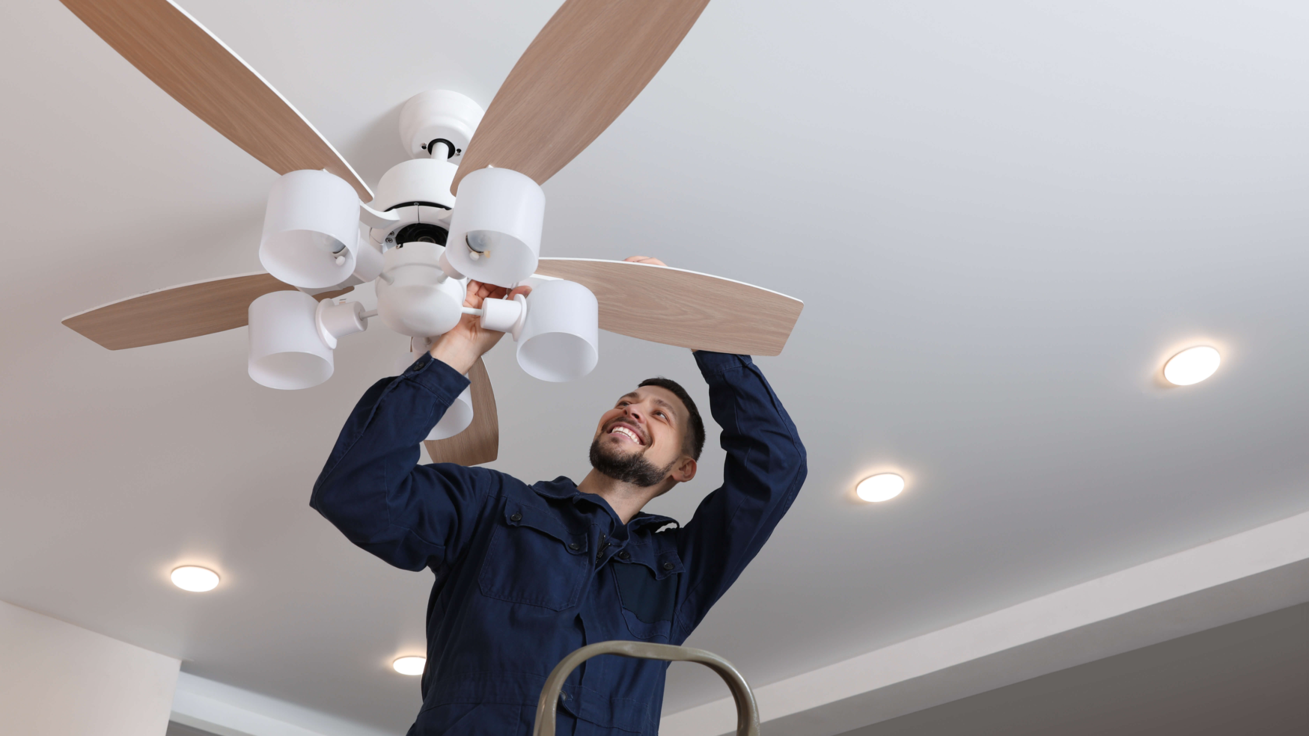 PowerMeans Electric technician in a dripping springs home repairing a ceiling fan.