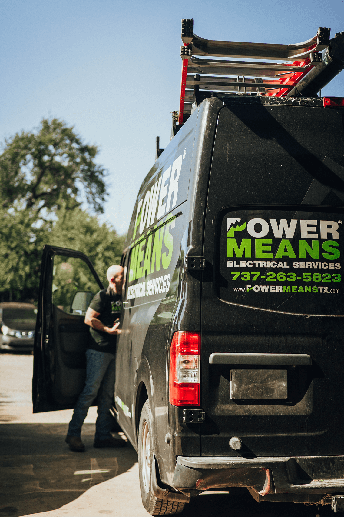 A PowerMeans Electrician getting into his van in front of a home in Bee Cave, Texas.
